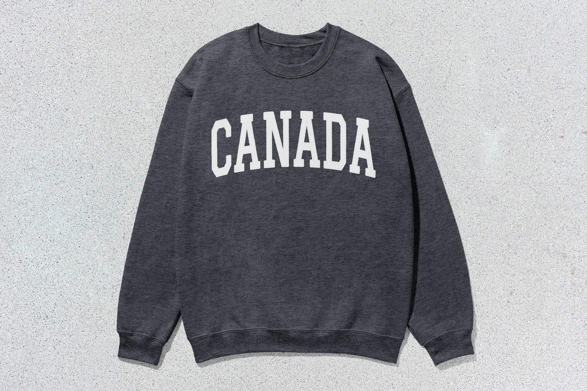 Gray crewneck sweatshirt with CANADA text, ideal for custom apparel and heavy blend use