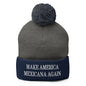 Gray and navy beanie with pompom from Make America Mexicana featuring Claudia Sheinbaum embroidered knit pom